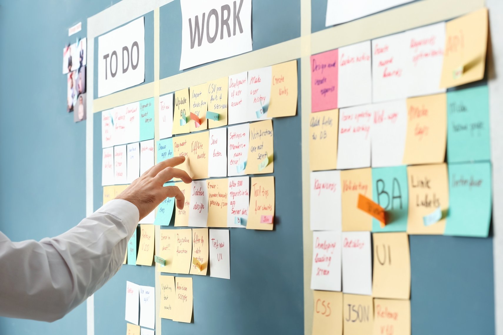 Young Man near Scrum Task Board in Office